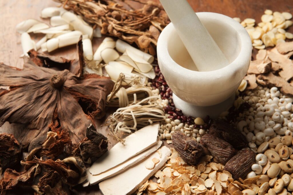 Chinese Herbal Medicine with Mortor and Pestle on Wood Hz